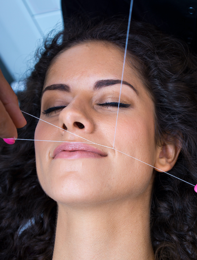A threading service shaping facial hair